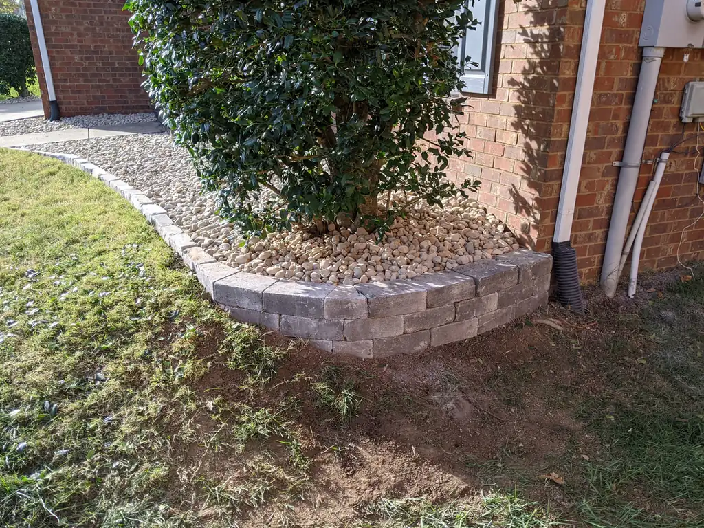 Small block planter wall around a tree at a brick home in Nashville, TN