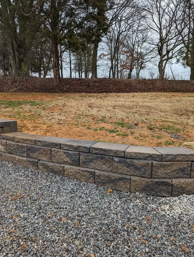 Block retaining wall with clean gravel backfill on a slope in Nashville, TN