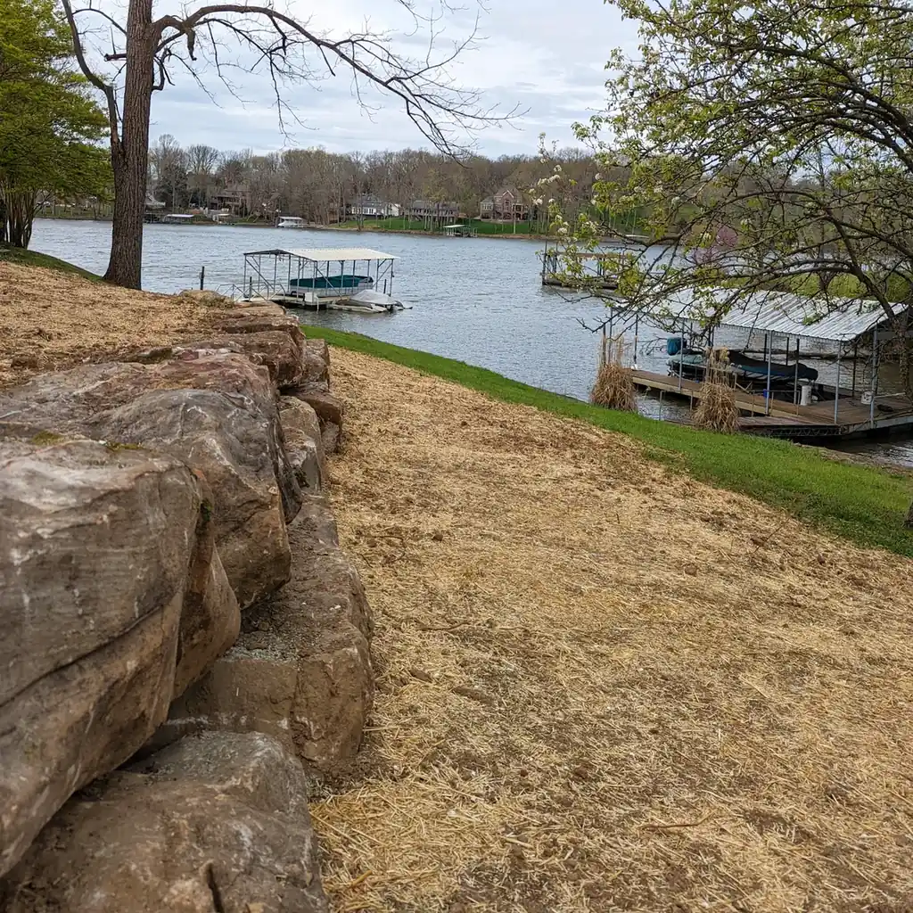 Boulder retaining wall stabilizing a lakefront slope in Middle Tennessee
