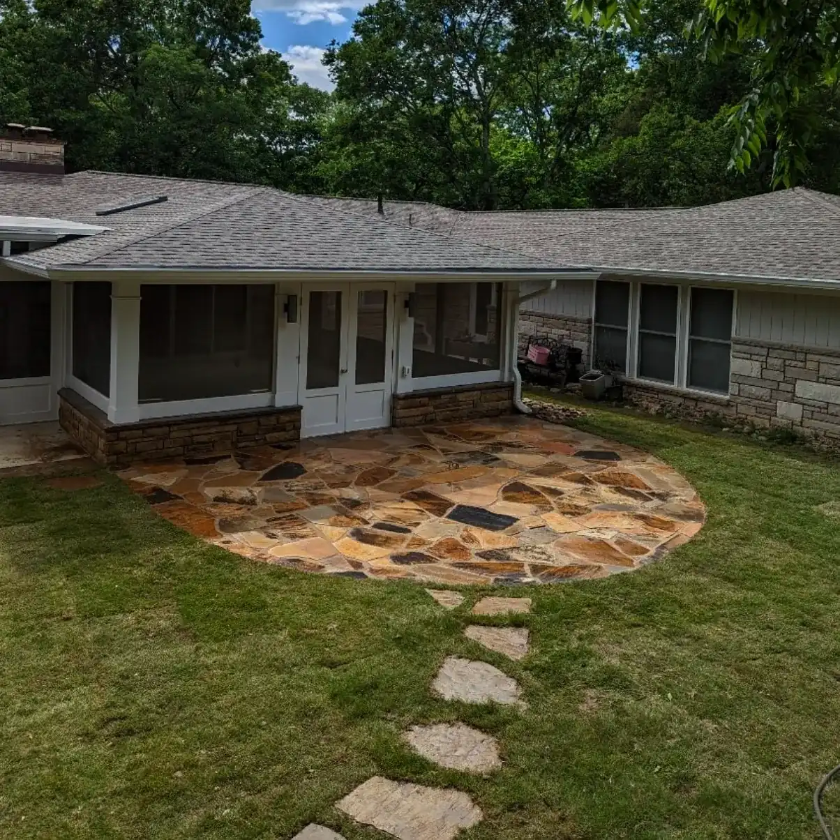Circular flagstone patio with a stepping stone path across the lawn of a ranch home in Nashville, TN