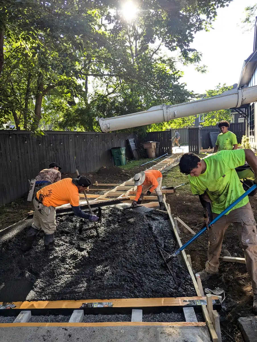 Alpine Landscaping crew screeding a wet concrete patio pour in Nashville, TN