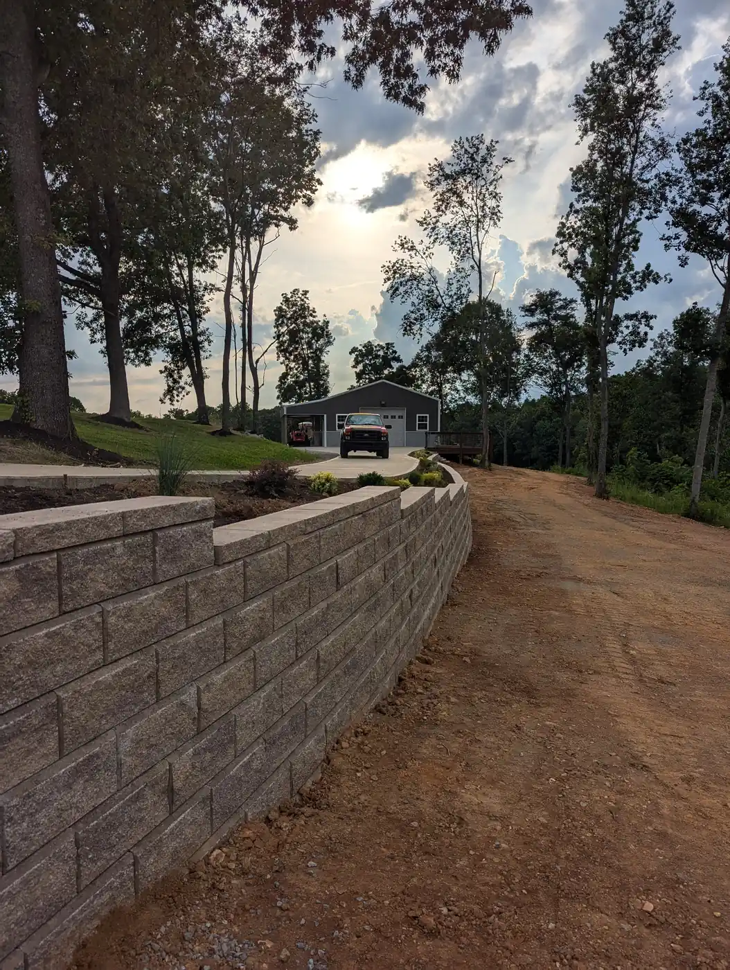 Curved block retaining wall along a driveway leading to a garage in Nashville, TN