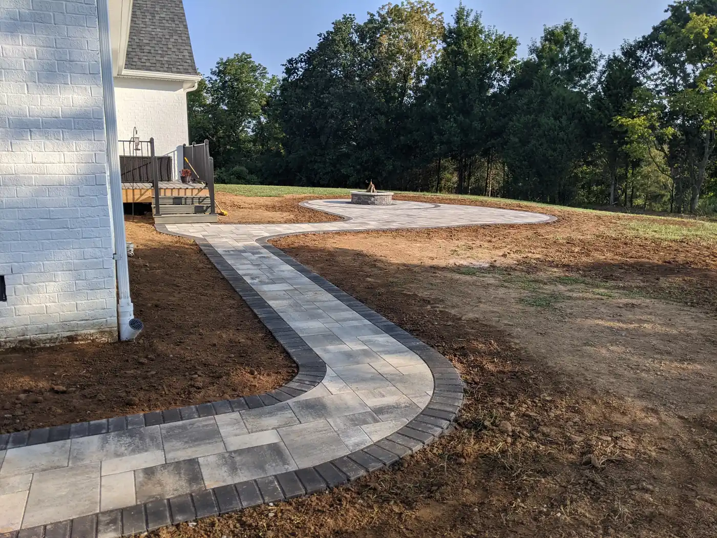 Curved paver walkway from house to patio across a freshly graded yard in Nashville, TN
