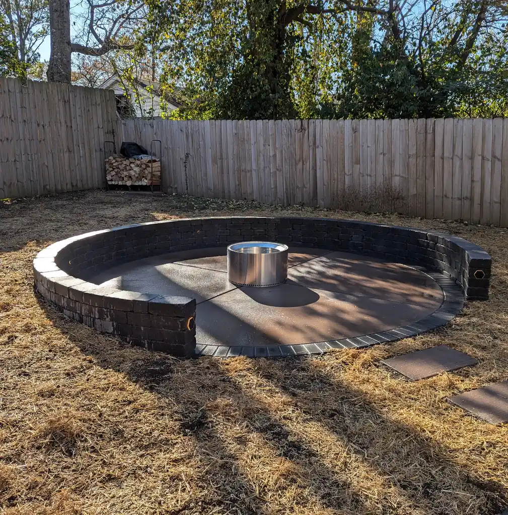 Fire pit patio with a dark block seat wall and stainless fire bowl in Nashville, TN