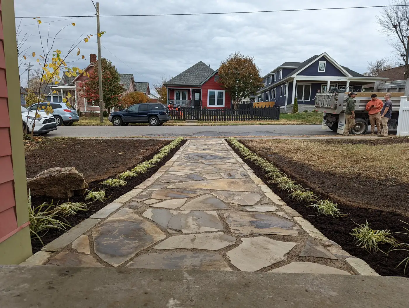 Finished flagstone front walkway lined with new plantings and mulch beds in Nashville, TN