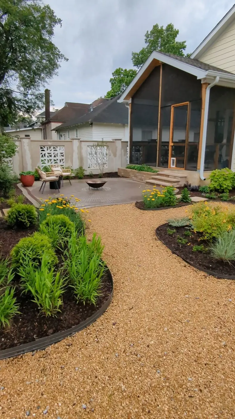 Gravel garden path bordered by newly planted beds behind a home in Nashville, TN