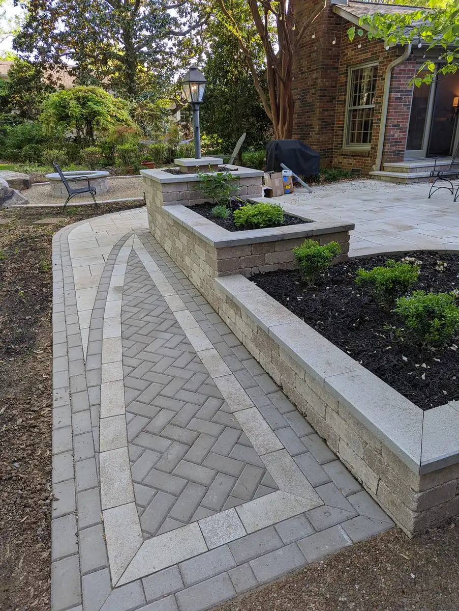 Herringbone paver walkway between raised block planter walls in Nashville, TN