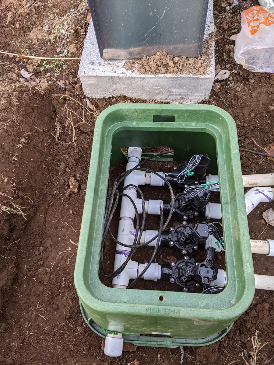 Irrigation valve box with a multi-zone manifold set in the ground in Nashville, TN