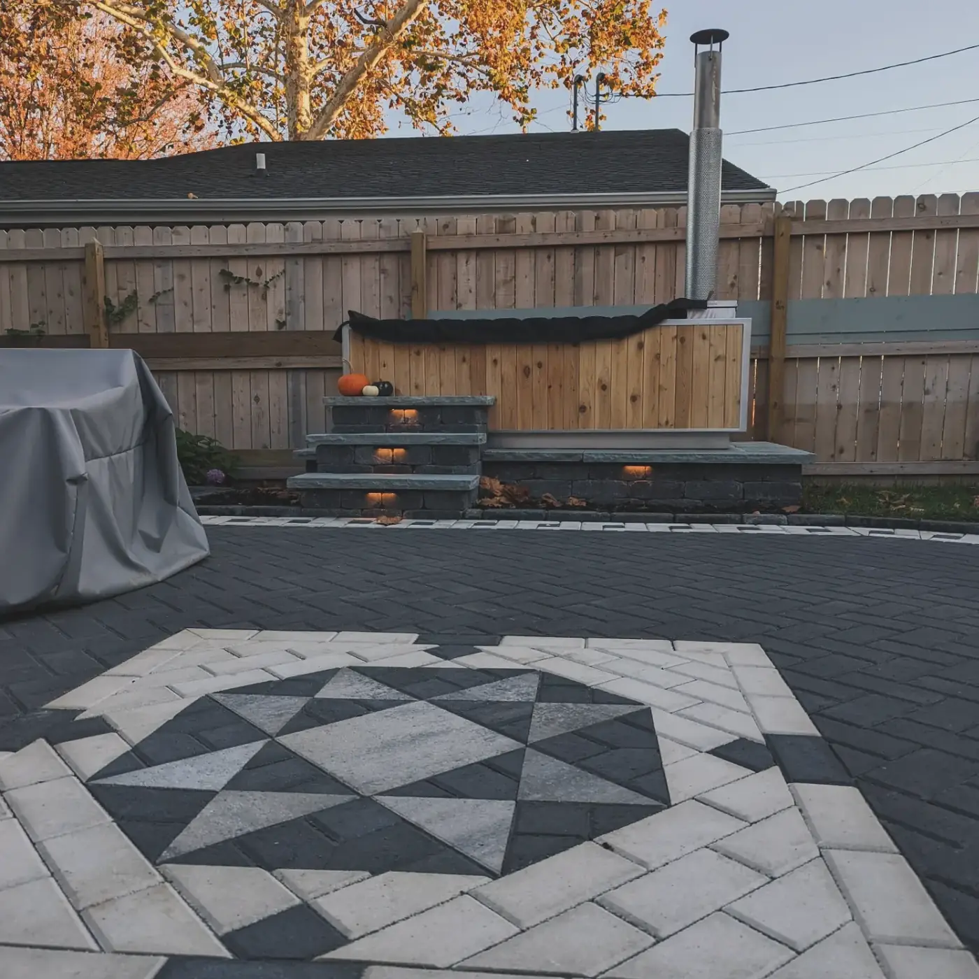 Paver patio with a star compass inlay, hot tub and steps in Nashville, TN