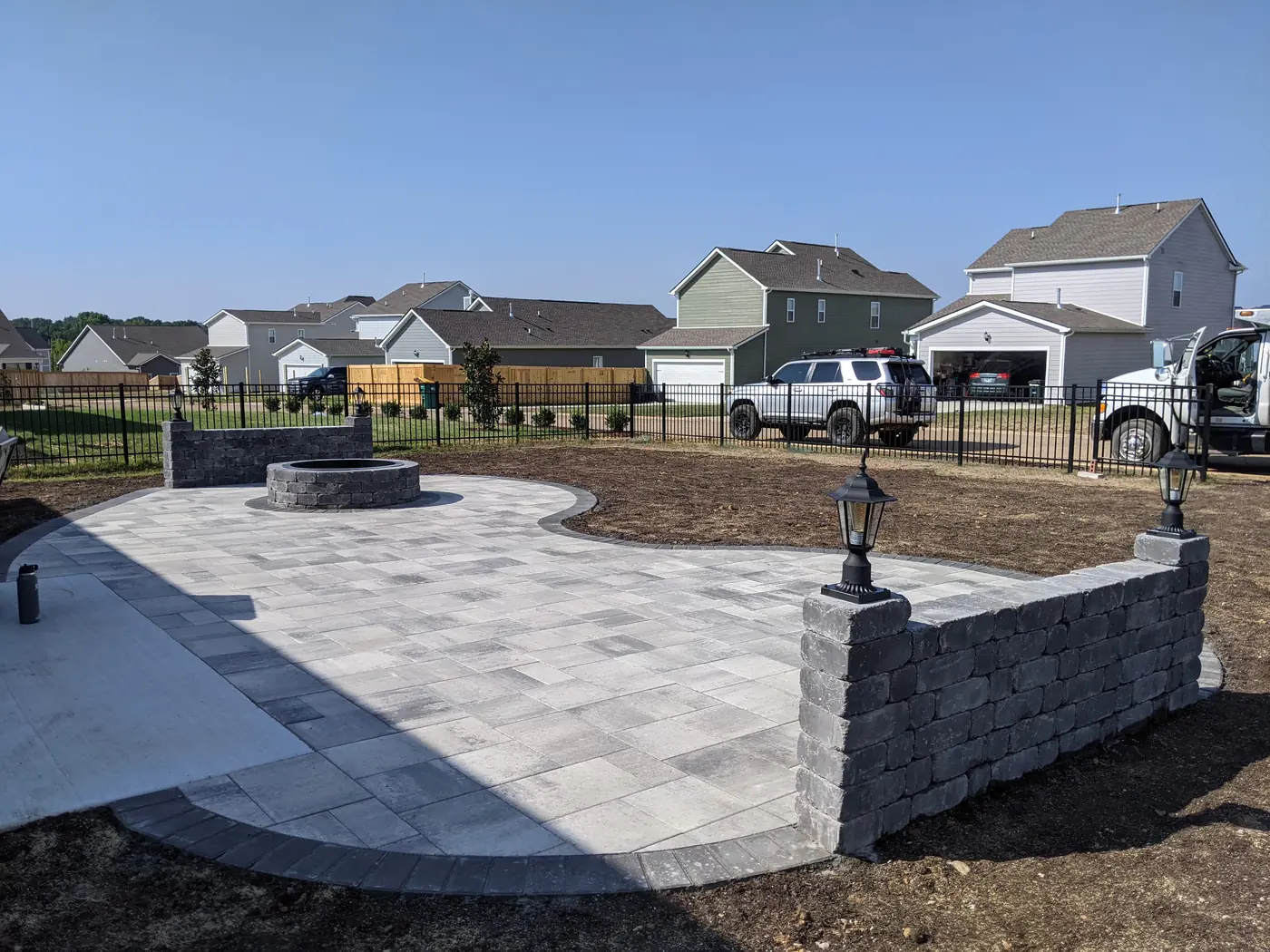 Raised paver patio with seat wall, pillar and fire pit in a new subdivision in Nashville, TN