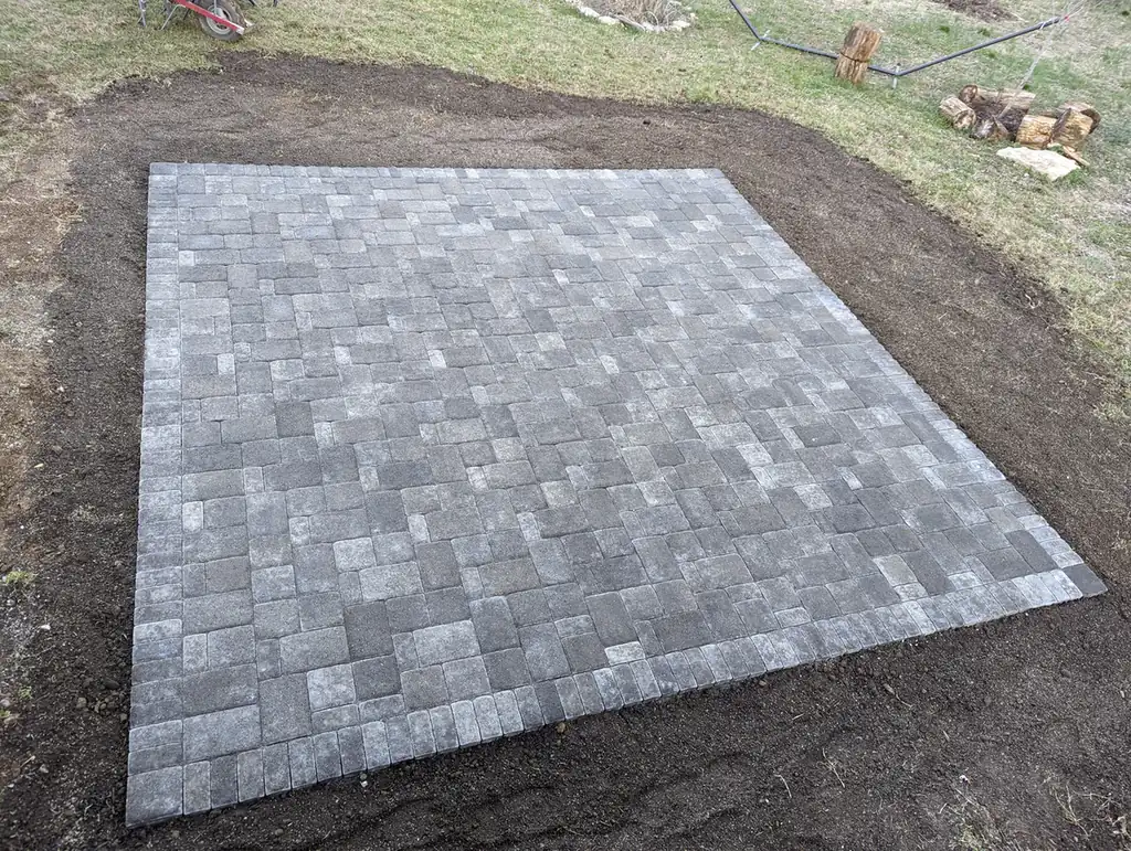 Rectangular paver patio with a dark border on freshly prepared ground in Nashville, TN