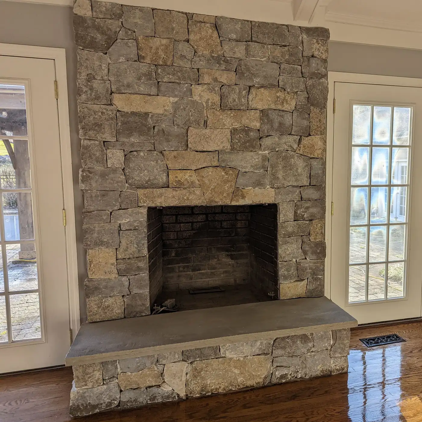 Stacked stone masonry fireplace with a slab hearth built by Alpine Landscaping in Nashville, TN